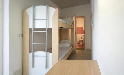 a room with two bunk beds and a table at I giardini di Santomaj in Leporano