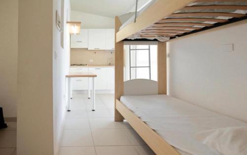 a room with a bed and a table in it at I giardini di Santomaj in Leporano