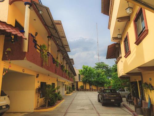 an alley between two buildings with a car parked at Hotel Hacienda la Alborada in Tuxtla Gutiérrez