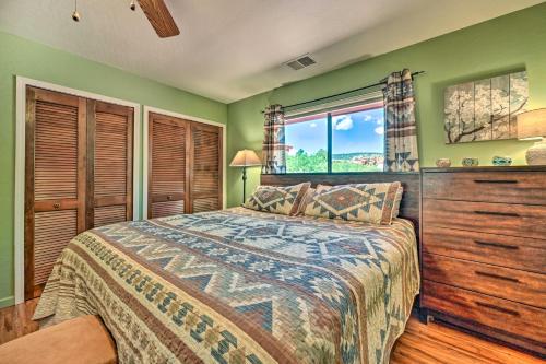 a bedroom with green walls and a bed and a window at Sunny Sedona Retreat with Scenic Red Rock Views in Sedona