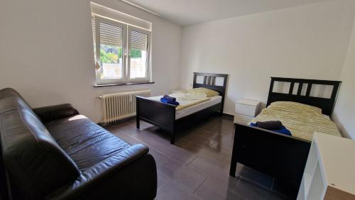 a living room with two beds and a couch at Apartments Overath in Overath