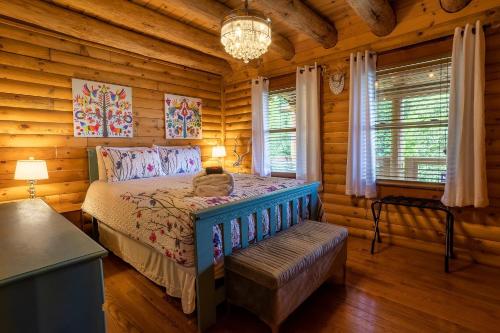 a bedroom with a bed in a log cabin at Mountain View Sanctuary in Weaverville