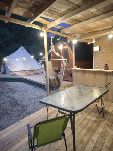 a patio with a table and chairs and a tent at Tiny House Village Resort 