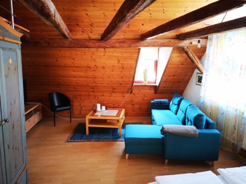a living room with a blue couch and a table at charmante Pension zentral in Reutlingen
