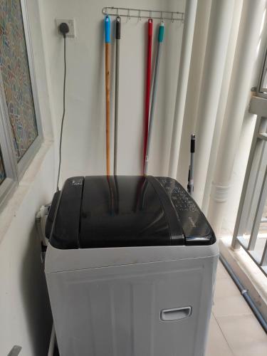 a fax machine sitting in a corner with baseball bats at Sutra Damai Seaview in Kuantan