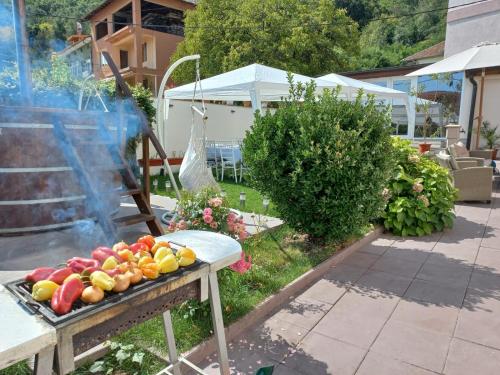 a grill with a bunch of fruit on a table at Sîrbu Orsova in Orşova
