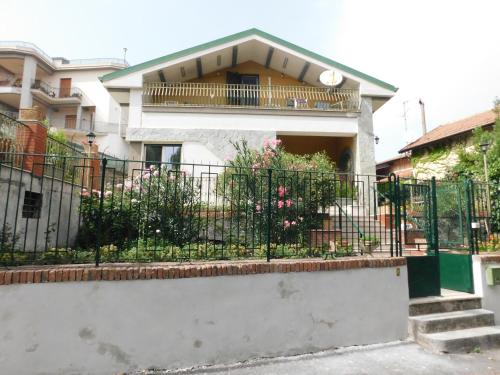 a house with a fence in front of it at Althea Etna Garden in Nicolosi