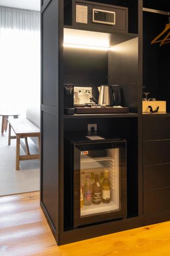 a kitchen with an oven with drinks in it at Quinta São Luiz The Vine House Douro in Tabuaço