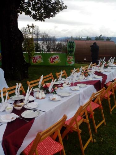 a long table with plates and napkins on it at Apart Hotel Sol y Lago in Pucón