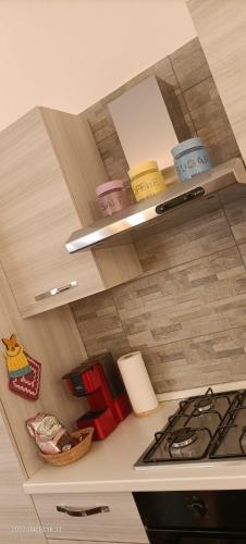 a kitchen with a counter top with a stove at Appartamento “Young” in Paderno Dugnano