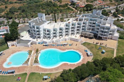 an aerial view of a resort with a swimming pool at Casa da Prainha - private pool, next to the beach in Alvor