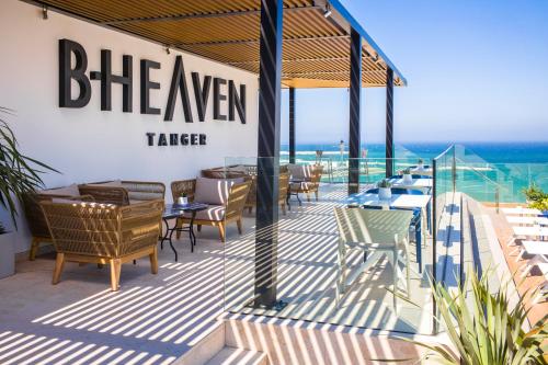 a restaurant with tables and chairs on a deck at Barceló Tanger in Tangier