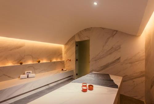 a room with marble walls and a table with cups on it at Barceló Tanger in Tangier