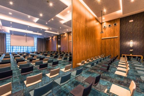 an empty conference room with chairs and a podium at Barceló Tanger in Tangier