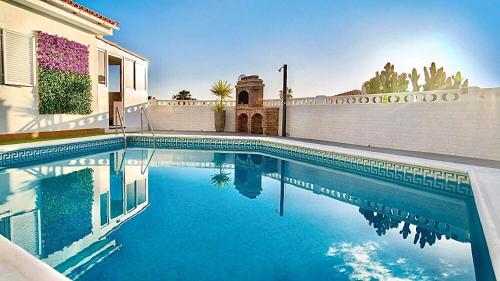 a swimming pool in front of a house at Villa Casa Amada in Callao Salvaje