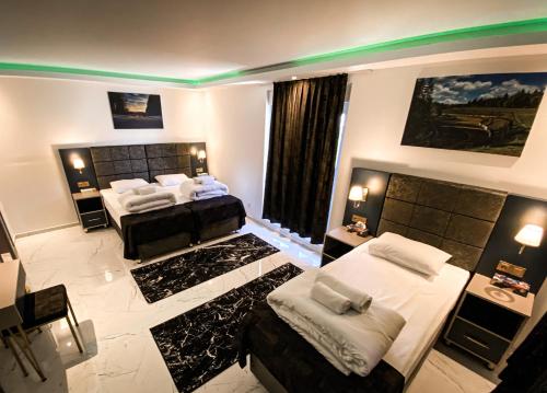 a bedroom with two beds and a large window at NRing Villa am Nürburgring in Adenau