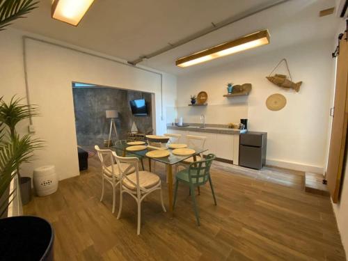 a dining room with a table and chairs and a kitchen at TORRE MAR Frente al Malecón in Mazatlán