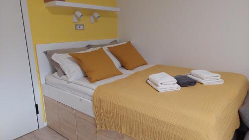 a bedroom with a bed with towels on it at Apartma Marjetica in Gozd Martuljek
