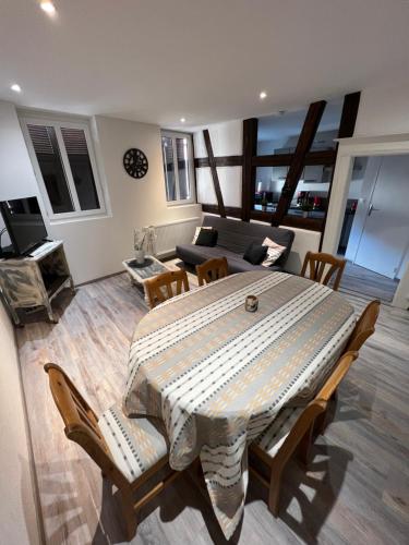 a living room with a large table and chairs at Chez Ben et Maé in Rouffach