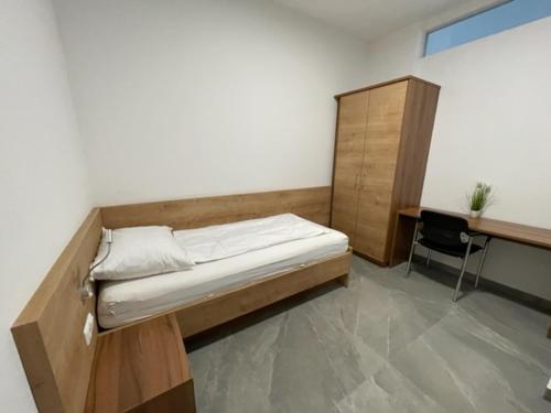 a bedroom with a bed and a desk in it at Wels Inn City Apartments in Wels