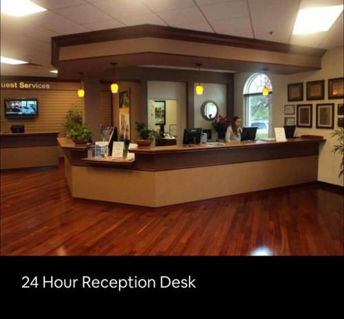 a reception desk in a hospital lobby with a woman at Serene family friendly townhouse in the wonderful Regal Palms in Davenport