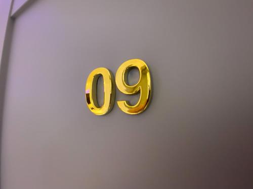 a gold number sign on a wall at NRing Villa am Nürburgring in Adenau