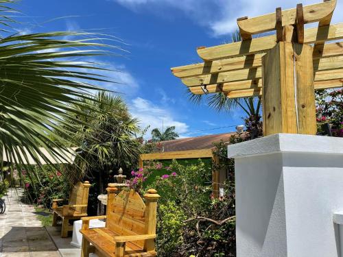 a wooden sign on a wall with a bench at Colony Club Inn & Suites in Nassau