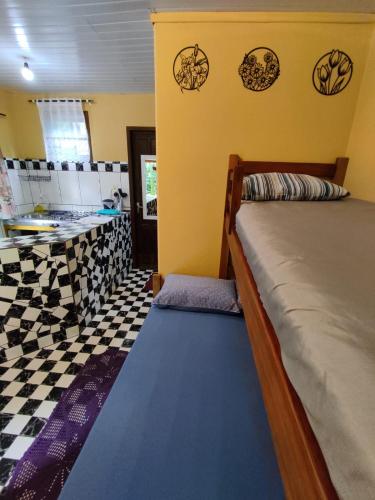 Ein Bett oder Betten in einem Zimmer der Unterkunft Morada das Flores Chalé/Kitnet