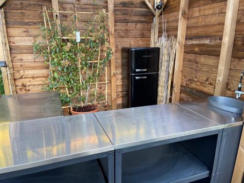a metal counter with a refrigerator in a room at VILLA LA PLAGE in Trouville-sur-Mer