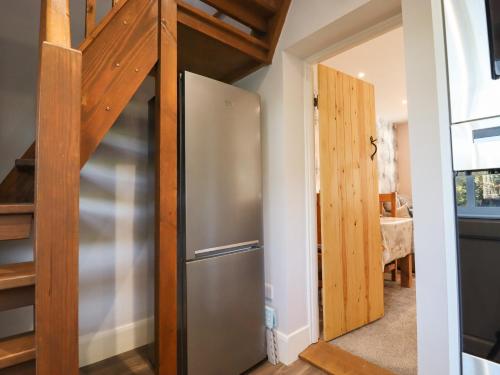 a kitchen with a stainless steel refrigerator in a room at Albies End in Battle