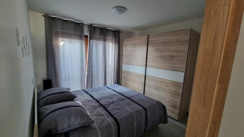 um quarto com uma cama e uma grande janela em Rossella B&B App 2 em Roeselare