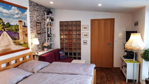 a bedroom with two beds and a door at Apartmá Za kopcem in Boskovice