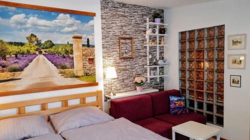 a living room with a couch and a painting on the wall at Apartmá Za kopcem in Boskovice