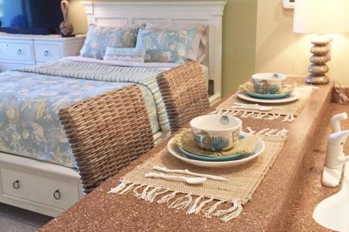 a bedroom with a bed with a table with dishes on it at Gated Sawgrass Beach Club Villa in Sawgrass Country Club in Ponte Vedra Beach