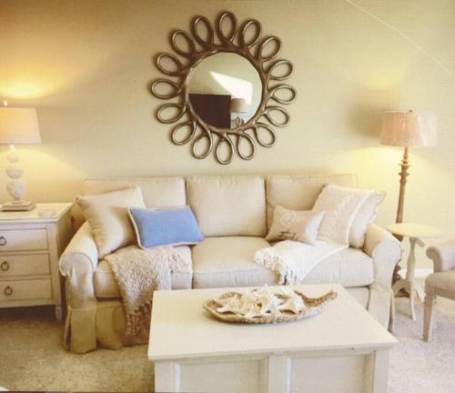 a living room with a couch and a mirror at Gated Sawgrass Beach Club Villa in Sawgrass Country Club in Ponte Vedra Beach