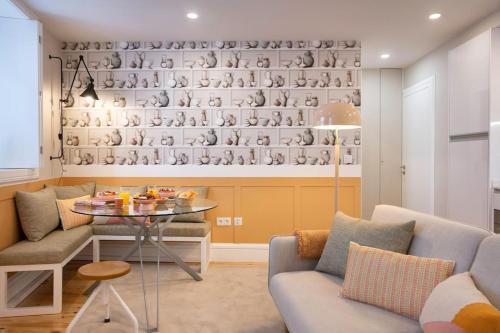 a living room with a table and a wall of cups at Away to Discover Apartment - hapiness has a place in Porto