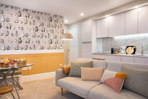 a living room with a couch and a table at Away to Discover Apartment - hapiness has a place in Porto