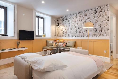 a bedroom with a bed and a dining room with a table at Away to Discover Apartment - hapiness has a place in Porto