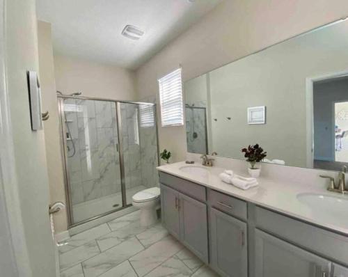 a bathroom with a shower and a toilet and a sink at Villa, private pool, water park, Orlando parks in Kissimmee