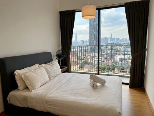 a bedroom with a bed with a large window at EkoCheras Residences by White Forest Suites in Kuala Lumpur