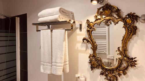 a bathroom with a mirror and towels on a shelf at Casa do Patio by Shiadu in Lisbon