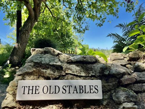a sign that says the old stables on a rock at The Old Stables in Lodsworth