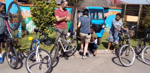 a group of people standing next to their bikes at Authentic Bicycle Tours and Backpackers in Soweto