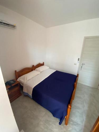 a bedroom with a bed in a white room at Petit gourmet in Siderno Marina
