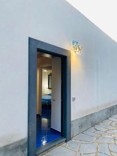 a doorway into a room with a light on a wall at Le Finestre di Amalfi in Amalfi