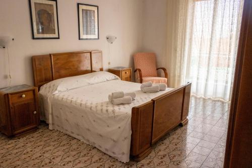 a bedroom with a bed with two towels on it at Casa Raffaela in Modica