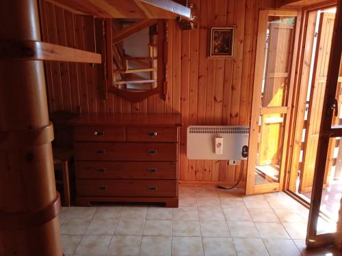 a room with a dresser and a mirror at La Tua Casa a Roccaraso in Roccaraso