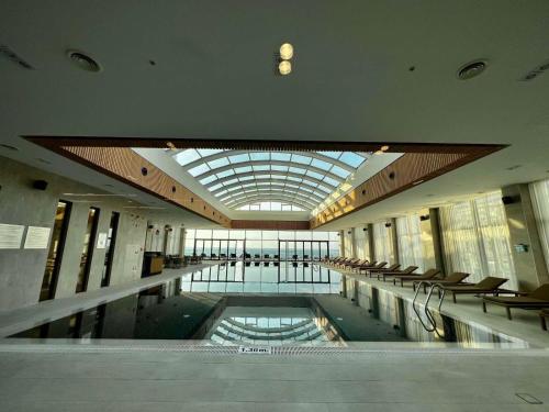 a large lobby with a pool in the middle of a building at Sunshine Apartments Batumi in Batumi