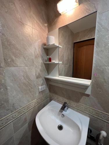 a bathroom with a sink and a mirror at V Check inn Sukhumvit 22 in Bangkok