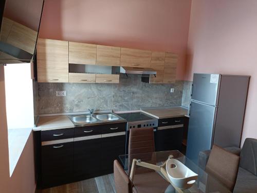 a small kitchen with a sink and a refrigerator at Lindos Villa Euphoria in Lindos